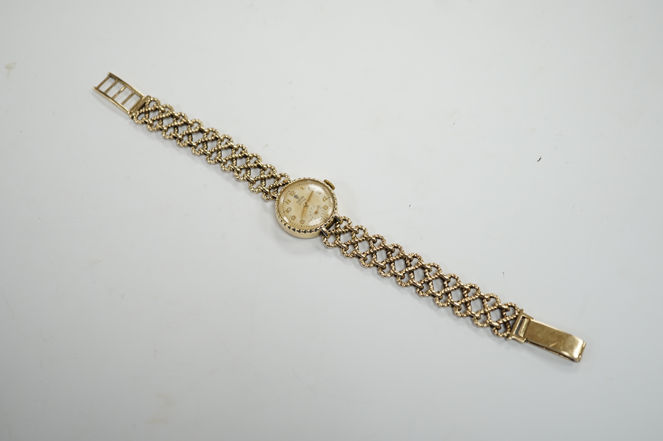 A lady's late 1950's 9ct gold Tudor Royal manual wind wrist watch, on a 9ct gold Rolex bracelet, overall 18.5cm, gross 22 grams, with Rolex box.